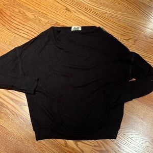 Black stylish top with zipper detail at neck that can be worn open off shoulder